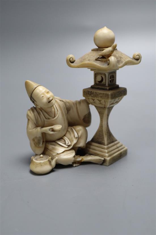 A fine 19th century Japanese ivory figure of a priest by a garden lantern, two character signature to a red lacquer seal, height 8cm